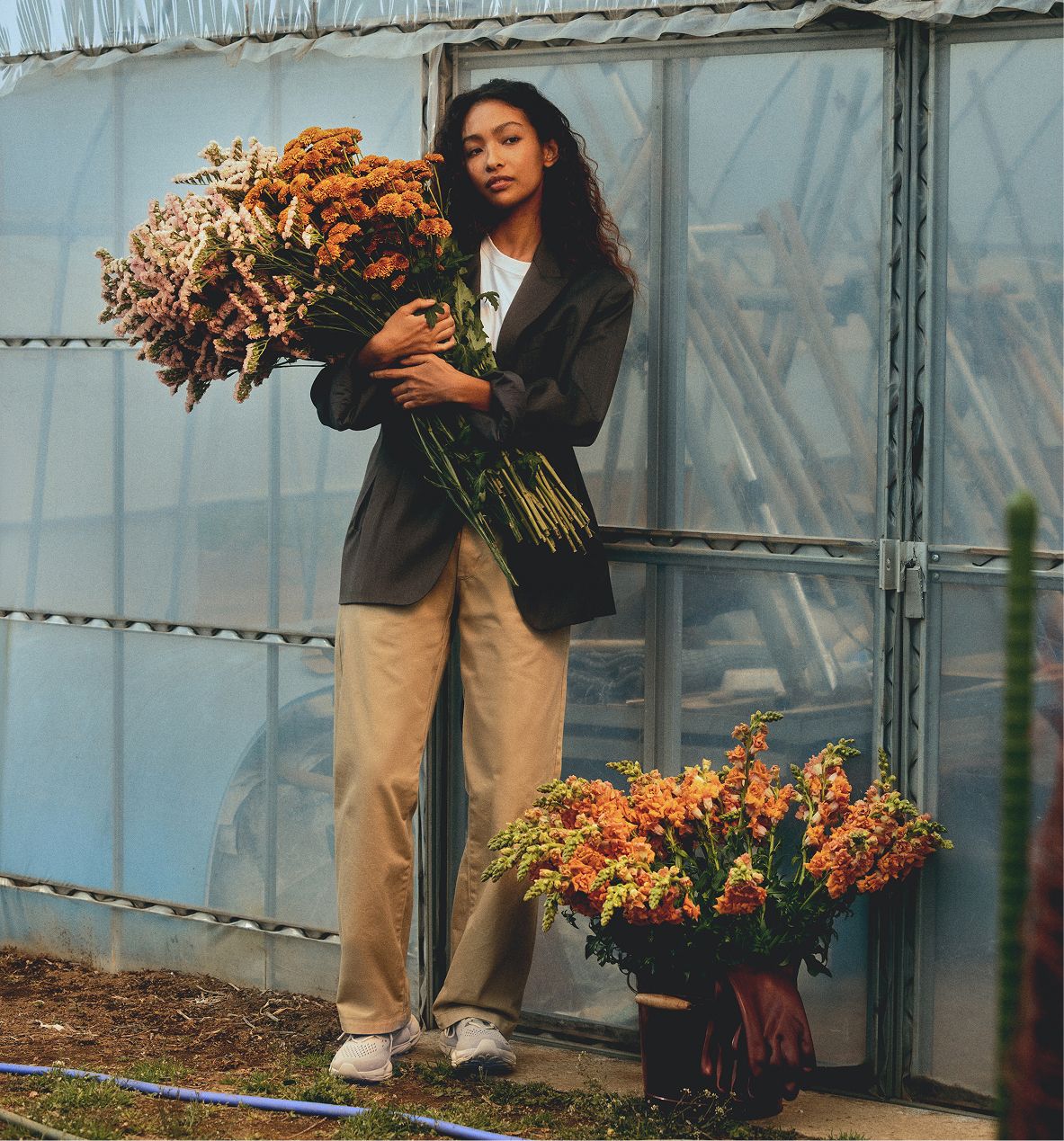 Woman wearing SpeedARC Trek shoes while holding flowers.